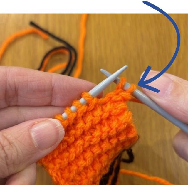 Photo of knitting with an arrow pointing to the right hand stitch on the right hand needle