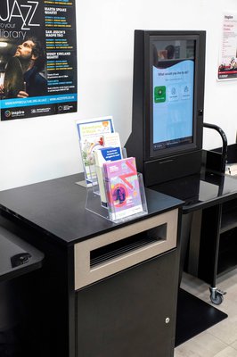 Self service kiosk showing touch screen and drop box for books
