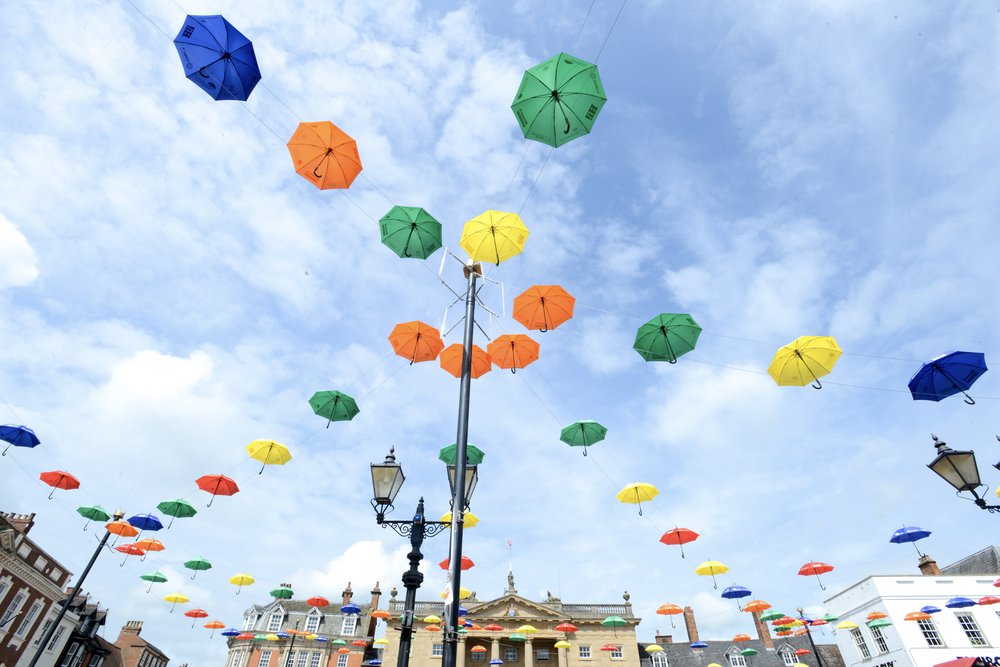 Colourful umbrellas hanging above Newark Market Place.