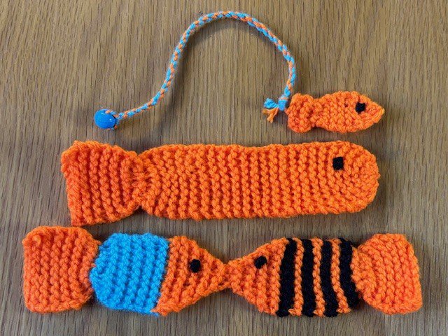 Three different knitted fish bookmarks