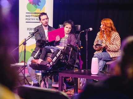 Photograph of poets from the Social Model Writers performing