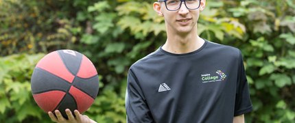 A young person holding a basketball.