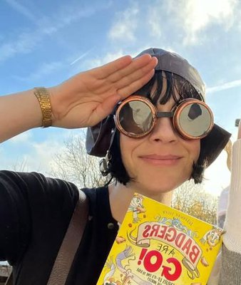 Photo of children's author Susannah Lloyd wearing flying goggles and saluting
