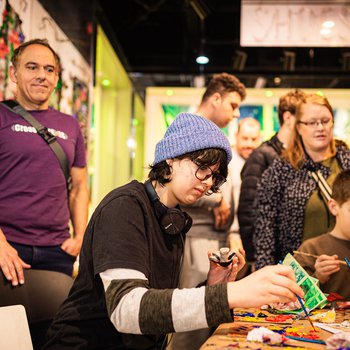 A group of people doing arts and arts at a table