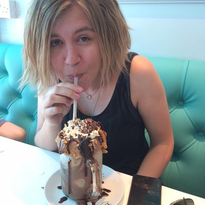 Photo of children's author Terrie Chilvers drinking a chocolate milkshake.