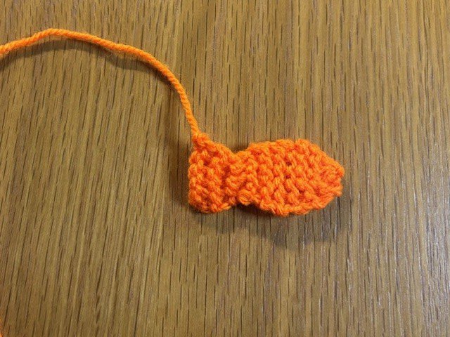 A small, flat knitted fish