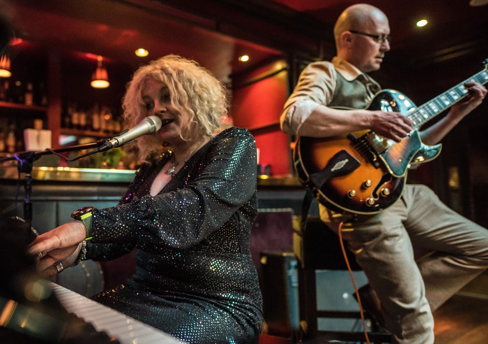 Wendy Kirkland at piano with guitarist to her side