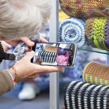 A crafter photographing her scarf