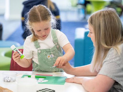 Parent and child crafting in a library