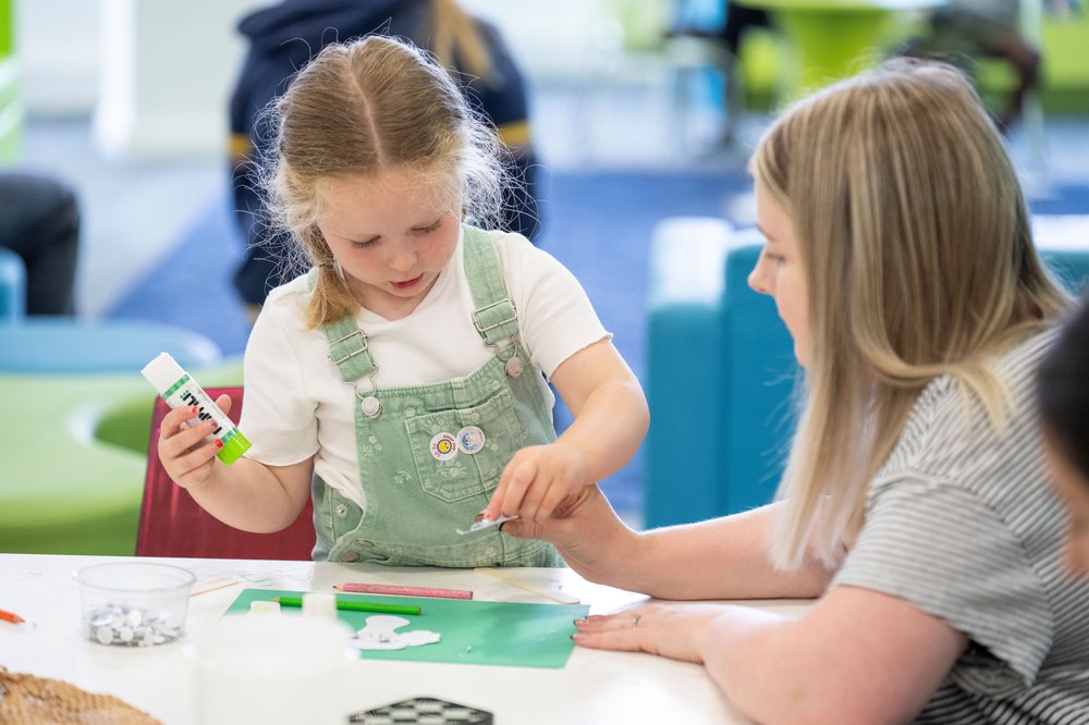 Parent and child crafting in a library