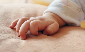 baby's hand on a blanket