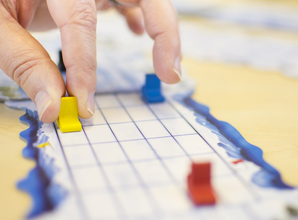A close up of a person playing a board game.