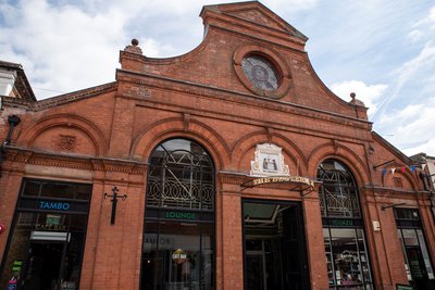 An outside photo of the Buttermarket in Newark - a historical building with large ornate windows