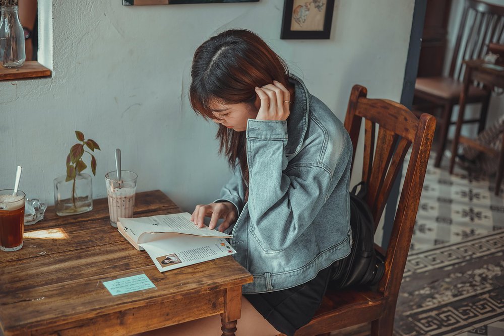 Someone sat reading in a cafe