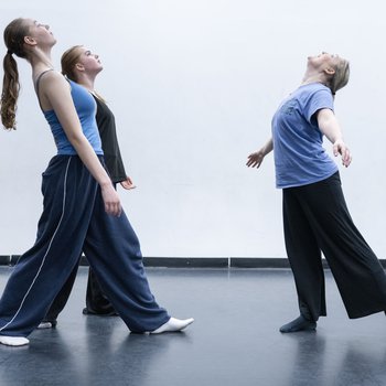 Three female dancers leaning backwards