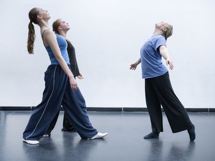 Three female dancers leaning backwards
