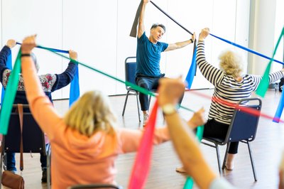 Photograph of a group of people taking part in chair based exercises