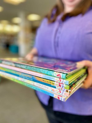 Stack of books from the parents collection, with handprints on the spines