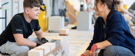 College student and tutor doing bricklaying