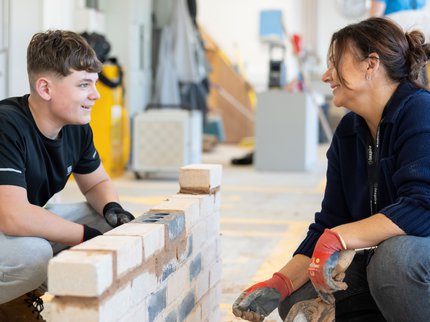 College student and tutor doing bricklaying