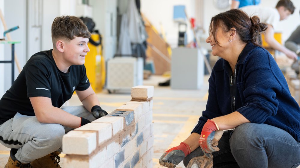 College student and tutor doing bricklaying