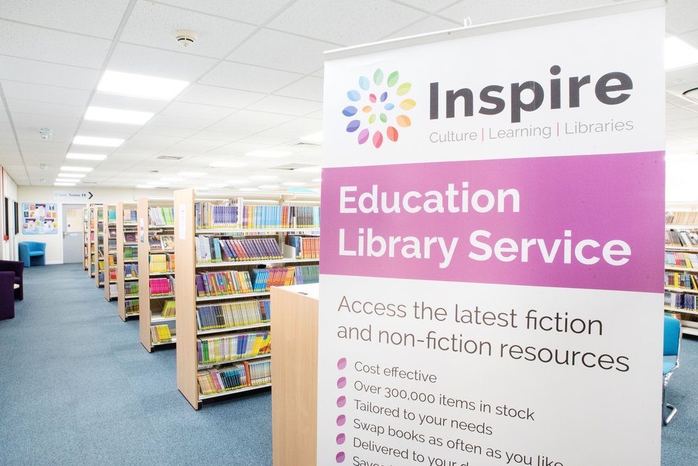 ELS bookshelves with a promotional banner about ELS in the foreground