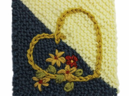 Embroidered flowers and a chain stitch heart on a Care Square