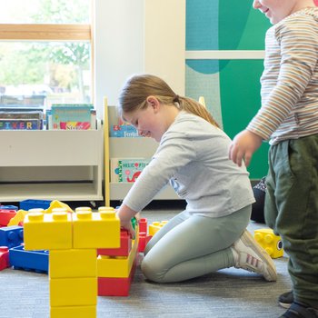 2 children building giant lego