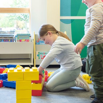 2 children building giant lego