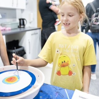 Girl using the Potter's Wheel to create a spin picture