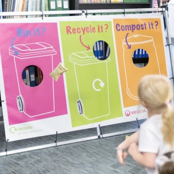 Young girl taking part in a recycling game