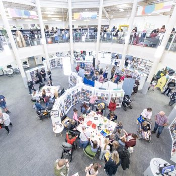 An inside view of Worksop Library (upstairs and downstairs) full of people doing Fun Palace activites