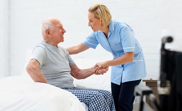 Health and social care worker helping elderly resident