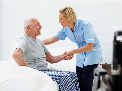 Health and social care worker helping elderly resident