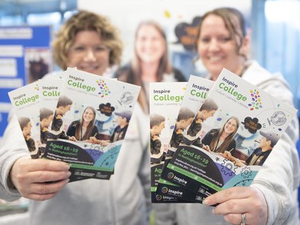 Tutors holding Inspire College brochure