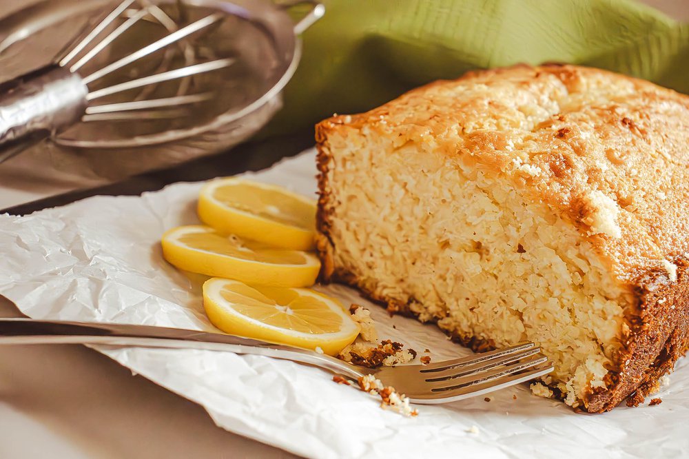 Lemon cake on a plate with slices of lemon