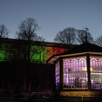 Brightly lit bandstand in front of a castle