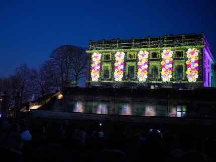 Colourful flowers projected on to Nottingham Castle