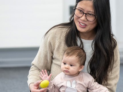 A woman holds her baby in her lap