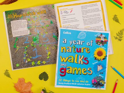 Two copies of the book 'a year of nature walks and games', one showing the closed book overlays a page spread title Hopscotch Walk. Coloured pencils, leaves and flowers surround the books.
