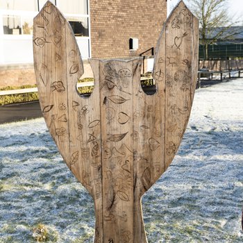 Back of the sculpture, with carvings of leaves and other flora from the children