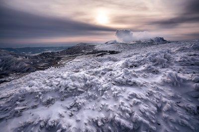 Panoramic view of a snowed mountain top extending to the horizon.