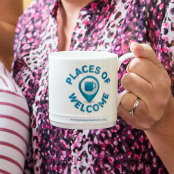 Two places of welcome white mugs