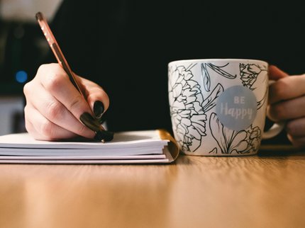 Close up of a person's hand while writing