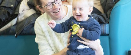 woman holding a child smiling