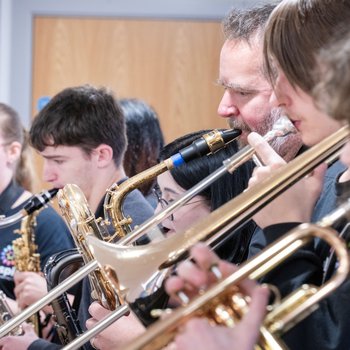 Members of the Red Hot Band playing brass instruments.