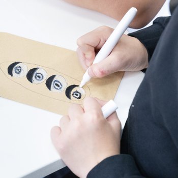 Child drawing on seed packet