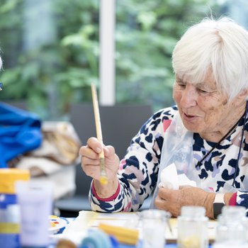 Two people painting and laughing together