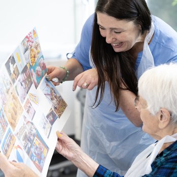 Artist showing examples of seaside postcards