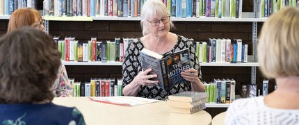 Someone sat reading a book at a book club